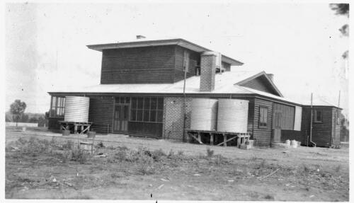 Unidentified house with water tanks [picture] : Fred McKay Cape York Peninsula and West Queensland Patrol 1938-1940 / [Fred McKay]