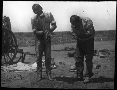 Two unidentified men having a wash in the bush, 1913 [transparency] / John Flynn