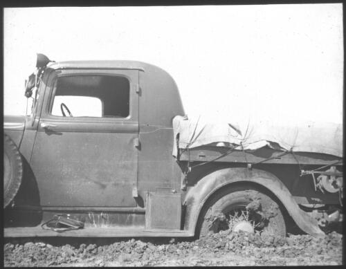 Utility truck bogged on dirt road, South Australia [transparency] : scene of mid-north South Australia used by Rev. F.H. Patterson on Stuart Patrol 1930+
