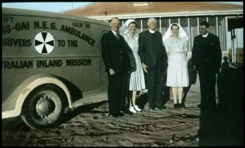 Missionaries and hospital staff with the Australian Inland Mission ambulance at Leigh Creek [transparency] : a lantern slide used in lectures on all Australian Inland Mission activities, 1940- / [John Flynn?]