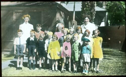 Group of children with teachers? [transparency] : a lantern slide used in lectures on all Australian Inland Mission activities, 1940- / [John Flynn?]