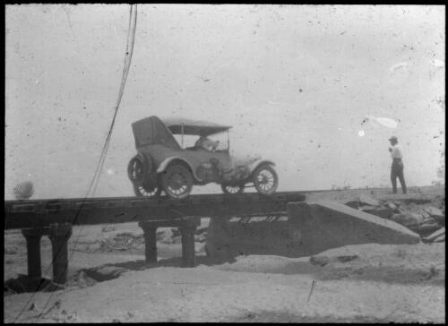 Vehicle on a bridge, Port Augusta - Oodnadatta Line? [transparency] : a lantern slide used in lectures on all Australian Inland Mission activities, 1940- / [John Flynn?]