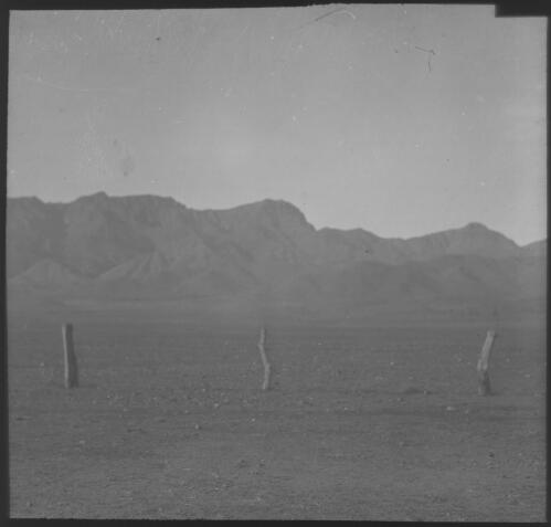 West MacDonnell Ranges, near Alice Springs, with three posts in foreground [transparency] : scene of mid-north South Australia used by Rev. F.H. Patterson on Stuart Patrol 1930+