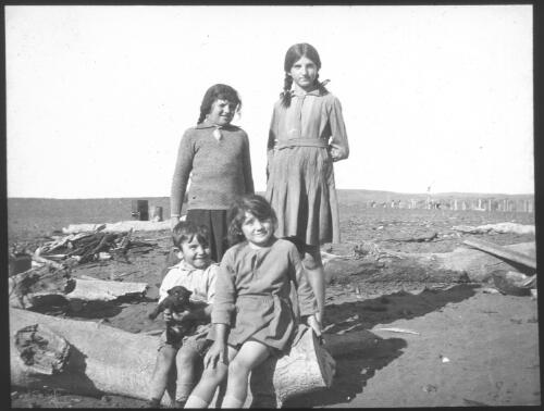Four unidentified children and a puppy, South Australia [transparency] : scene of mid-north South Australia used by Rev. F.H. Patterson on Stuart Patrol 1930+