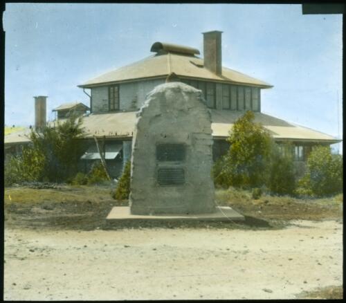 Innaminka Hostel with Sturt monument in foreground, South Australia [transparency] : a lantern slide used in lectures on all Australian Inland Mission activities, 1940- / [John Flynn?]