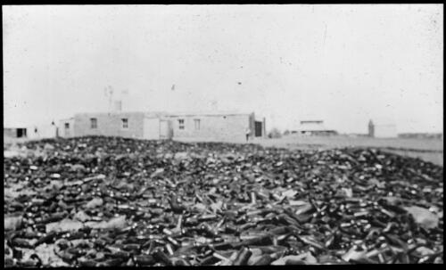 Famous bottle heap at Innamincka [transparency] : a lantern slide used in lectures on all Australian Inland Mission activities, 1940- / [John Flynn?]