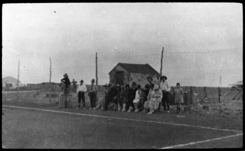 Group of people alongside a tennis court [transparency] : a deputation slide of the AIM [Australian Inland Mission] Head Office, 1926-1940/ [John Flynn?]
