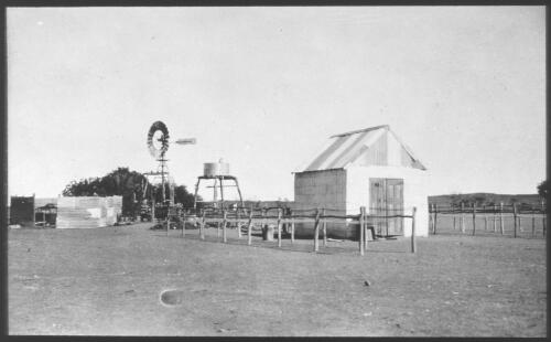 Unidentifed tin shed, water tank and windmill, South Australia [transparency] : scene of mid-north South Australia used by Rev. F.H. Patterson on Stuart Patrol 1930+