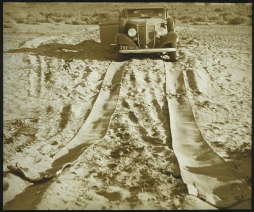 Car crossing sand over matting, South Australia [transparency] : scene of mid-north South Australia used by Rev. F.H. Patterson on Stuart Patrol 1930- [John Flynn?]