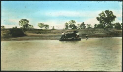 Three men trying to move a car across the river [transparency] : a lantern slide used in lectures on all Australian Inland Mission activities, 1940- / [John Flynn?]