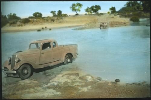 Cars making their way across a river [transparency] : a lantern slide used in lectures on all Australian Inland Mission activities, 1940- / [John Flynn?]