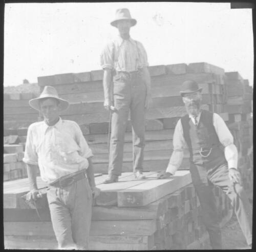 Three unidentified men with railway sleepers, Beltana, South Australia [transparency] : part of South Australian and other AIM [Australian Inland Mission] scenes used by Rev. F.H. Patterson