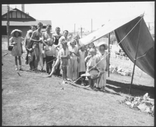 Group of children standing beside a tent [transparency] : part of South Australian and other AIM [Australian Inland Mission] scenes used by Rev. F.H. Patterson