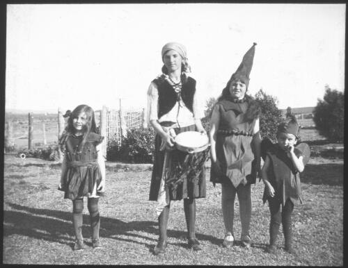 Group of four children, three dressed in elfin costumes and one dressed in a gypsy costume [transparency] : part of South Australian and other AIM [Australian Inland Mission] scenes used by Rev. F.H. Patterson