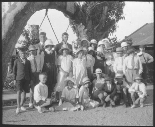 Group of unidentified children at the Old Gum Tree, Gelenelg? [transparency] : part of South Australian and other AIM [Australian Inland Mission] scenes used by Rev. F.H. Patterson