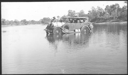 Car with people inside crossing the Moonlight River, South Australia [?] [transparency] : scene of mid-north South Australia used by Rev. F.H. Patterson on Stuart Patrol 1930+