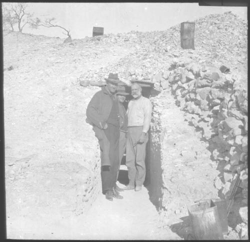Three unidentified men standing in entrance to mine [transparency] : part of South Australian and other AIM [Australian Inland Mission] scenes used by Rev. F.H. Patterson