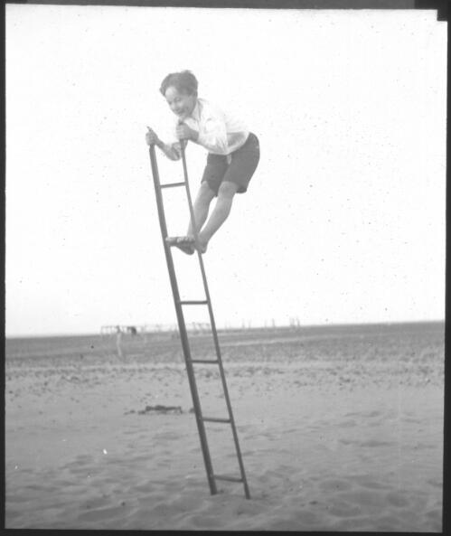 Unidentified boy balancing on a ladder, South Australia [transparency] : scene of mid-north South Australia used by Rev. F.H. Patterson on Stuart Patrol 1930+