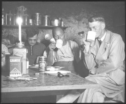 F.H. Patterson having tea with two other unidentified men, South Australia [transparency] : scene of mid-north South Australia used by Rev. F.H. Patterson on Stuart Patrol 1930+