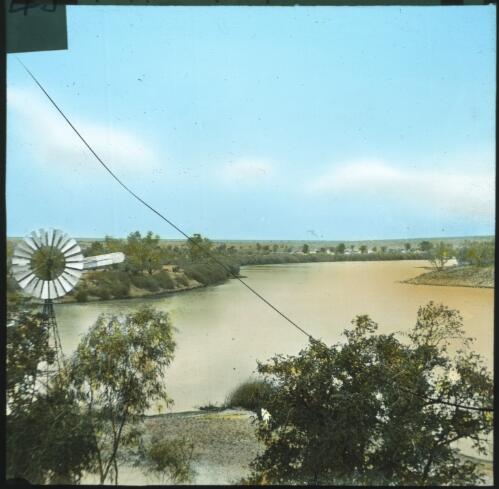 Windmill on river bank, Nappamerry [transparency] : a lantern slide used in lectures on all Australian Inland Mission activities, 1940- / [John Flynn?]