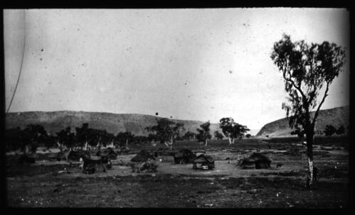 Several grass huts [transparency] : a lantern slide used for publicity in South Australia / [John Flynn]