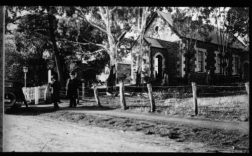 Two unidentified gentlemen standing in front of Clare Presbyterian Church, South Australia [transparency] : a lantern slide used for publicity in South Australia / [John Flynn]