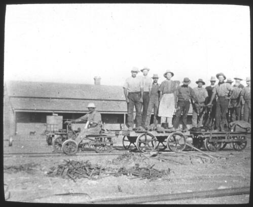Fettlers on trike, trailer and Kalamazoo, probably during construction of the Trans-Australia railway line [transparency] / [John Flynn?]