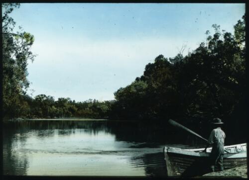 Unidentified man standing next to a boat, Katherine River, Northern Territory [transparency] : part of a mixed selection of lantern slides and negatives from John Flynn's teaching days in Gippsland, and early AIM [Australian Inland Mission] activities / John Flynn