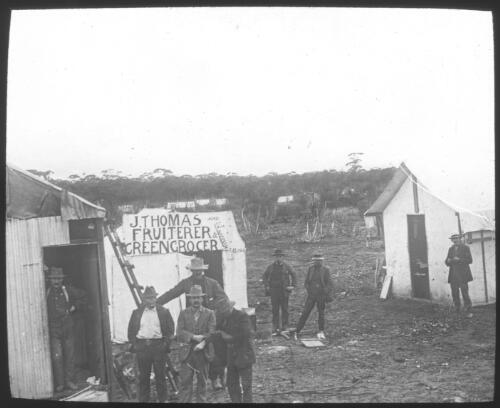 Unidentified early campsite with a fruiterer and greengrocer tent [transparency] / [John Flynn?]