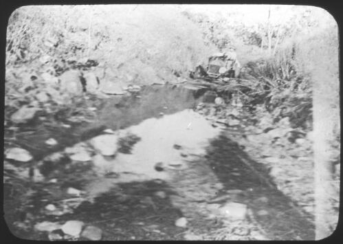 Unidentified man in car on way to Victoria River Downs, Northern Territory [transparency] / [John Flynn?]