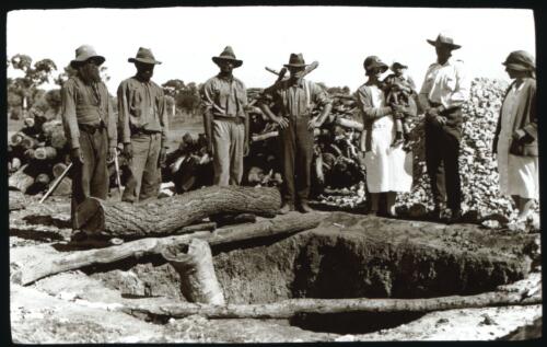 Group of unidentified people looking into a lime kiln [transparency] : part of a mixed selection of lantern slides and negatives from John Flynn's teaching days in Gippsland, and early AIM [Australian Inland Mission] activities / John Flynn