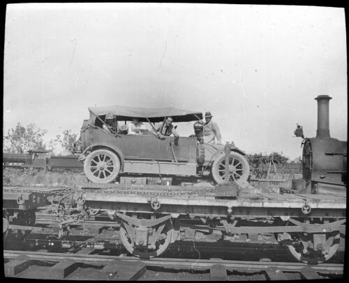Freight train with car loaded on top, Northern Territory [transparency] : inland people and general scenes / [John Flynn?]