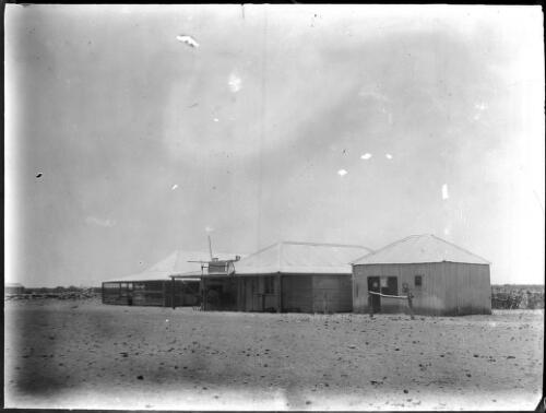 View of a building with a wagon in the shed [picture] : an image used by the Australian Inland Mission at Dunbar, Cape York / [John Flynn?]