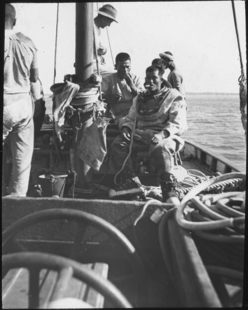 Japanese pearl divers, with Victor Kepert aboard a pearl lugger, Broome, Western Australia, ca. 1914, 2 [transparency] / John Flynn