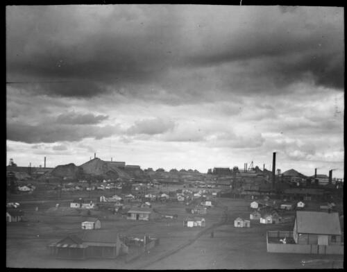 Cottages and other buildings surrounding an unidentified mine [transparency] : part of mixed selection of lantern slides and negatives from John Flynn's teaching days in Gippsland, and early AIM [Australian Inland Mission] activities / John Flynn