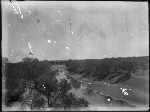 View of river bank, river and trees [picture] : an image used by the Australian Inland Mission at Dunbar, Cape York / [John Flynn?]