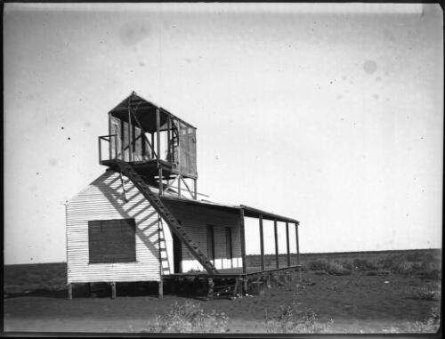 Dwelling with ladder and wooden structure on top [picture] : an image used by the Australian Inland Mission at Dunbar, Cape York / [John Flynn?]