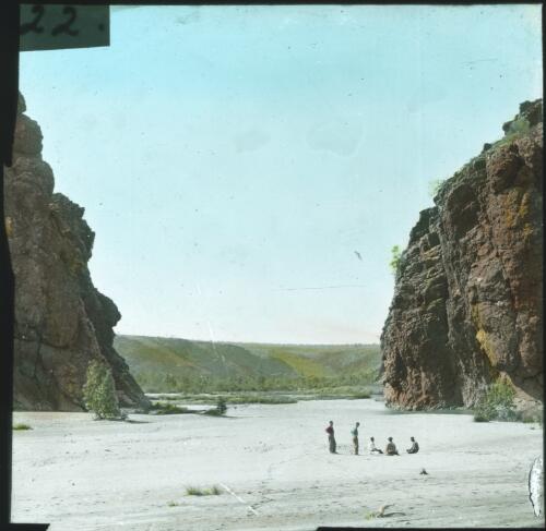 Group of men in the foreground of rocky cliffs [transparency] : a lantern slide used in lectures on all Australian Inland Mission activities / [John Flynn?]