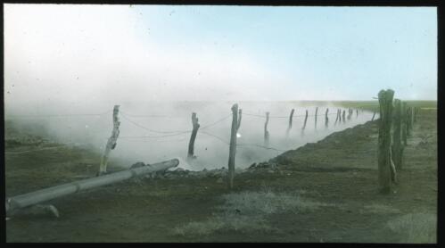 Mist rising from water pipe running through arid land [transparency] : part of scenes of the Northern Territory and North Western Australia / [John Flynn?]