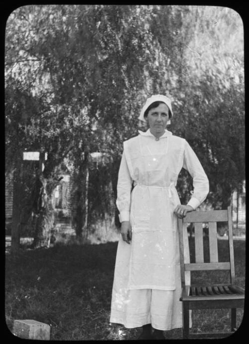 Unidentified nurse standing next to a chair [transparency] / [John Flynn?]