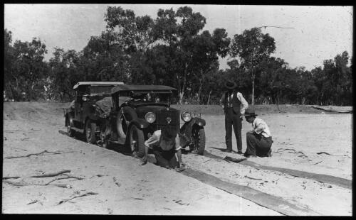 Mats being laid to prevent the cars from being bogged [transparency] : a lantern slide used by John Flynn in lectures / [John Flynn]