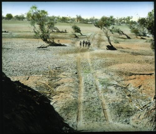 Men walking along a track near Margaret River crossing [transparency] : a lantern slide used in lectures on all Australian Inland Mission activities / [John Flynn?]