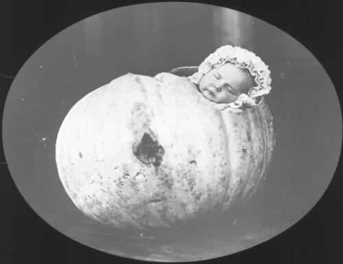Unidentified baby lying in a hollowed out pumpkin [transparency] : a lantern slide from John Flynn's missionary days in Gippsland 1906-7 / John Flynn