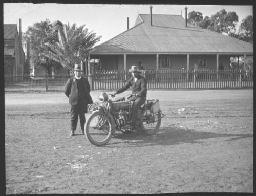 A clergyman with an unidentified man on a motorcycle [transparency] : taken during the Resonian trip to the Northern Territory led by John Flynn / [John Flynn?]