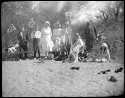 Unidentified group portrait with two boys holding Australian flags [transparency] : scenes of the Diamantina area and other general scenes / [John Flynn?]
