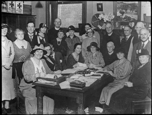 Melb. O.I. [Group of men and women in an office] [transparency] / [John Flynn?]
