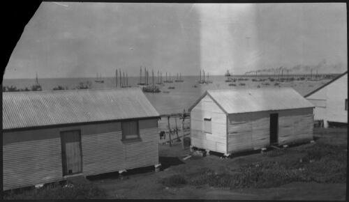 Corrugated iron sheds and boats anchored at Derby, Western Australia? [picture]