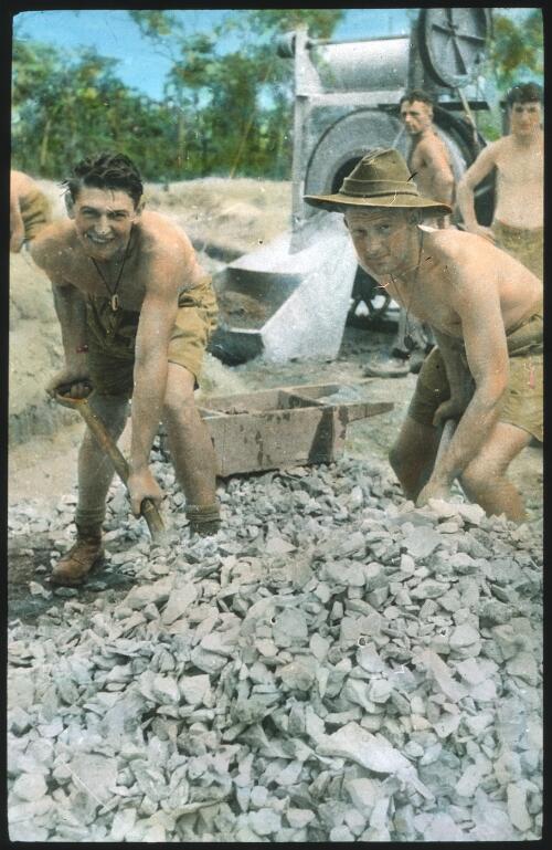Unidentified Australian Army soldiers shovelling rocks [transparency] : scenes of Army life in Australia during World War II / [John Flynn?]