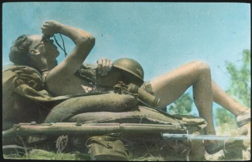 Unidentified Australian Army soldier relaxing on sandbags [transparency] : scenes of Army life in Australia during World War II / [John Flynn?]
