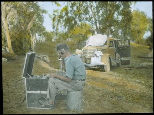 Reverend Fred McKay operating the pedal-powered wireless, [3] [transparency] : scenes from the North Australia Patrol and other general scenes, 1937-1942 / [John Flynn?]